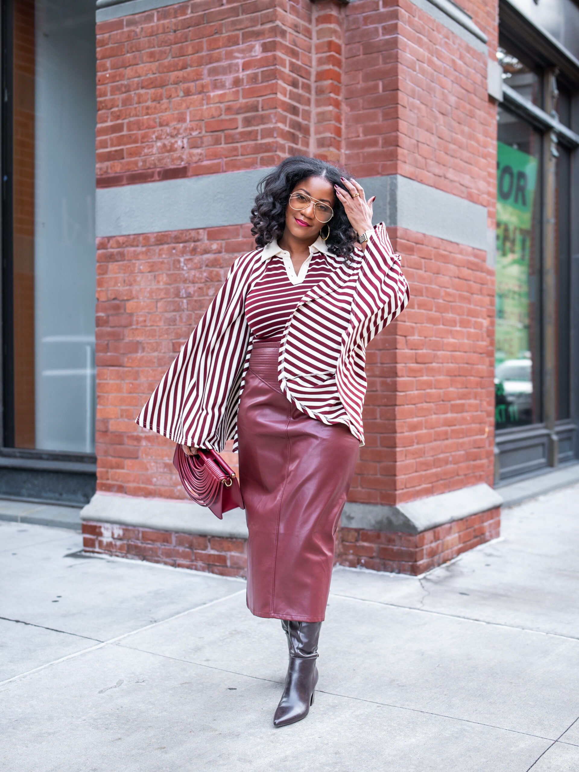 Burgundy striped oversized shirt with faux leather midi skirt and black boots styled for Easter Sunday church